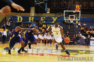 Senior point guard Frantz Massenat drives past a double-team in the Dragons’ 63-54 victory against Hofstra University Feb. 18 at the DAC. Massenat scored 16 points and four assists against the Pride, shooting 4-9 from the field and 7-8 from the foul line.