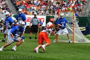 Senior Syracuse University midfielder JoJo Marasco drives to the net against sophomore Duke University goalie Kyle Turri. Duke won the 2013 NCAA Men’s Lacrosse Championship.