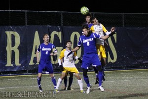 Senior midfielder Ken Tribbett leaps with the Hofstra University defense in an attempt to produce a scoring chance. Tribbett netted three goals last season, all of which were of the game-winning variety.