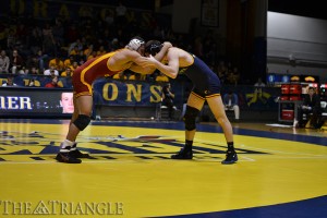 Senior Austin Sommer grapples with an Iowa State University wrestler Jan. 1 at the DAC. This fall, the Dragons will make their debut in a new conference, the EIWA.