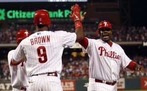 The Philadelphia Phillies’ Ryan Howard, right, celebrates his first-inning run scored with teammate Domonic Brown against the Washington Nationals Sept. 27, 2012, at Citizens Bank Park in Philadelphia.