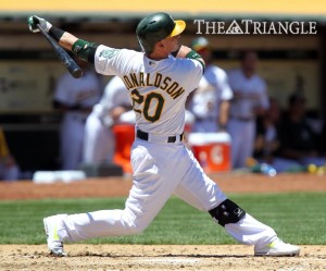 Oakland Athletics third baseman Josh Donaldson follows through after connecting for a three-run homer off Cincinnati Reds pitcher Homer Bailey during the fourth inning at O.co Coliseum in Oakland, Calif., June 26.