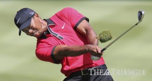 Tiger Woods takes up some turf with his shot on the sixth fairway during the fi nal round of the World Golf Championships Bridgestone Invitational at Firestone Country Club in Akron, Ohio, Aug. 4.