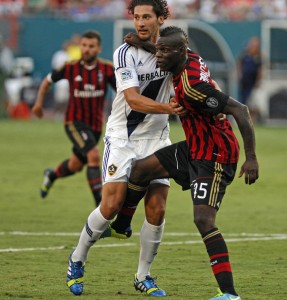 AC Milan’s Mario Balotelli, right, tries to break free of Los Angeles Galaxy defender Omar Gonzalez in first-half action in the third-place game of the International Champions Cup at Sun Life Stadium in Miami Aug. 7.