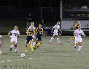 Senior Christine Stevenson dishes the ball to sophomore Civanni Moss during Drexel’s 3-0 loss to Liberty University Sept. 6 at Vidas Field. Moss leads the Dragons with two assists so far this season.