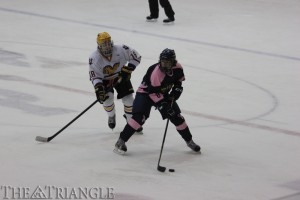 Sophomore defenseman John Quigley defends the puck against West Chester University defenseman Jeff Dugan during the Rams’ 6-4 victory over the Dragons Oct. 26 at the Class of 1923 arena. Quigley has tallied two goals and two assists for Drexel this season.