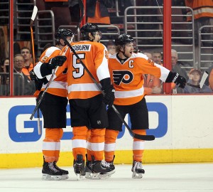 Philadlephia Flyers center Claude Giroux celebrates his goal Dec. 23, 2013, against the Minnesota Wild with teammates Braydon Coburn and Michael Raffl.