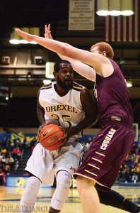 Senior power forward Dartaye Ruffin attempts a shot against a towering College of Charleston defender during Drexel’s 56-45 victory Feb. 26.