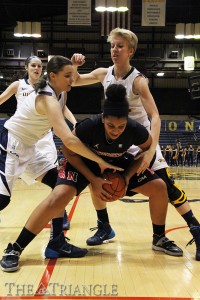 Freshman Sarah Curran (left) and redshirt sophomore Jackie Schluth (right) pressure Amencie Mercer of Northeastern University during Drexel’s 55-52 win Jan. 26.