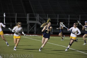 Junior midfielder Joelle Hartke looks down-field March 12 on the road. The Dragons failed to win another road game the rest of the season. (Ajon Brodie, The Triangle)