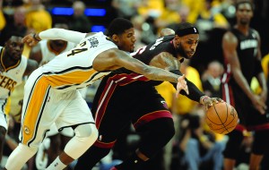 LeBron James, right, chases down the ball in front of the Indiana Pacers’ Paul George during the second half on May 28, 2014. (Michael Laughlin - Sun Sentinel/MCT Campus)