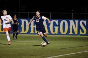 Senior John Grosh dribbles around a Princeton University defender. Grosh has been a mainstay on the team, making starts for the Dragons in each of his four years with the team (Photo Courtesy - Ken Chaney)