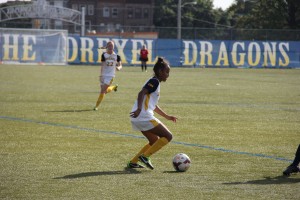 Junior midfielder Civanni Moss attempts to dribble passed a University of North Carolina Wilmington defender during a 1-0 victory over the Seahawks Sept 28. The victory was the fourth straight for the streaking Dragons team.  (Photo courtesy-Ajon Brodie The Triangle)