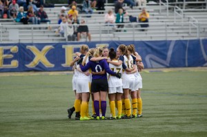 Kelsie Fye leads a team huddle before Oct. 4 game against University of Delaware. (Ken Chaney - The Triangle)