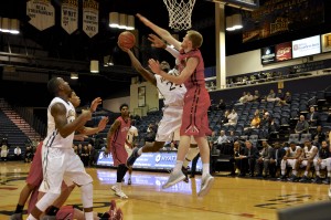 Rodney Williams goes up for a shot against Northeastern's Scott Eatherton on Jan. 28. (Adam Hermann - The Triangle)