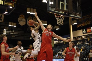 Guard Damion Lee (left) goes up for a shot against Northeastern University's Scott Eatherton on Jan. 28. (Adam Hermann - The Triangle)