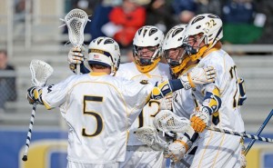 Men's lacrosse celebrates a goal against Saint Joseph's University. (Photo Courtesy - Drexeldragons.com)