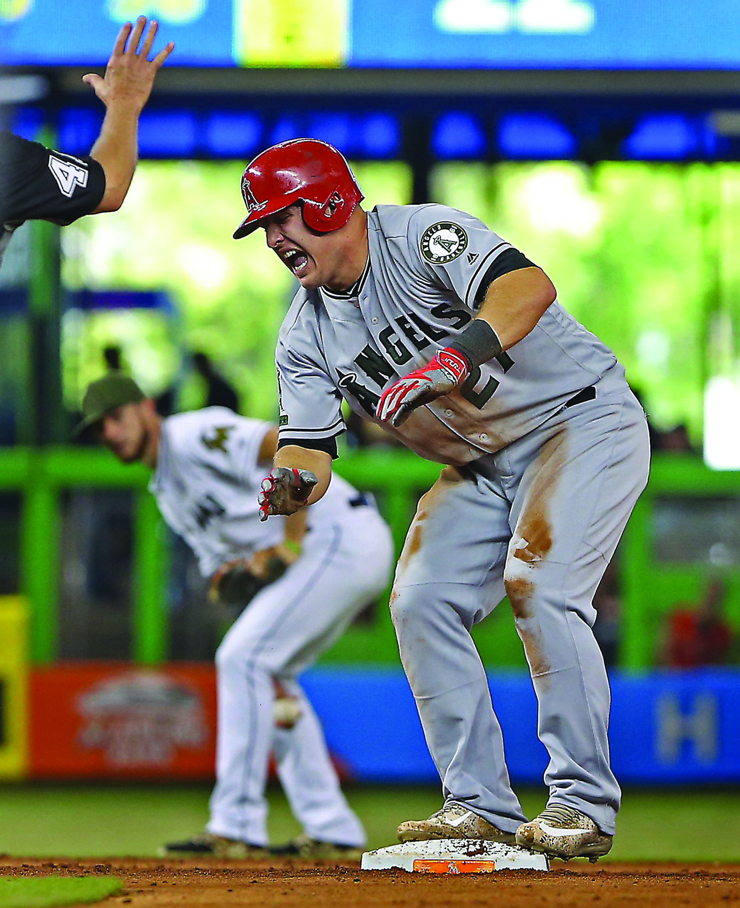 Los Angeles Angels&apos; Mike Trout (27) grimaces after hurting his hand sliding safely into second base during the fifth inning against the Miami Marlins on Sunday, May 28, 2017 at Marlins Park in Miami, Fla. (Patrick Farrell/Miami Herald/TNS)